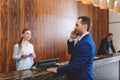 Presentable man standing at reception desk