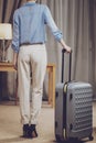 Presentable woman standing next to suitcase