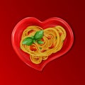 Presentation of pasta. Spaghetti on a red heart-shaped plate with red cherry tomatoes and green basil leaves