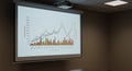 A presentation room features a large screen displaying a graph with multiple colorfu Royalty Free Stock Photo