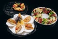 Presentation of three dishes on a black background