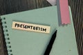 Presenteeism write on sticky notes isolated on Wooden Table