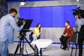 Presenters and video camera operator working in studio