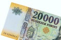 Presenting detailed of a twenty thousand forint cash banknote, which is commonly used as Hungarian currency.