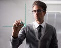 Presenting his business strategy. A young businessman writing on glass with a marker. Royalty Free Stock Photo