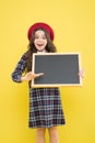 Presenting product. small girl in french beret. happy girl with curly hair in beret. advertisement. child with empty