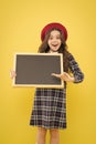 Presenting product. small girl in french beret. happy girl with curly hair in beret. advertisement. child with empty