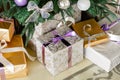 Presents and Gift boxes under Christmas Tree. boxes with ribbon bow. New year decorated house interior. Winter Holiday Royalty Free Stock Photo