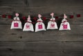 Presents with hearts hanging on wooden background for celebrations.