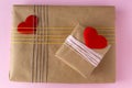 Presents packed for valentine`s day with organic paper and hearts. Royalty Free Stock Photo