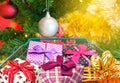 Presents ribbon gift box in shopping trolley cart with christmas tree and balls decorations and blurred lights