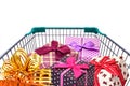 Presents ribbon gift box in shopping trolley cart on white background