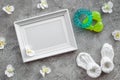 Presents set for baby shower with orchid and frame gray stone background top view mockup