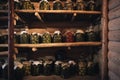 Preservation of vegetables in a warm cellar for winter period. Glass jars with pickled cucumbers on the shelf. Royalty Free Stock Photo