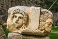 Preserved bas-reliefs with floral ornaments and faces, Demre, Antalya, Turkey. Theater masks Royalty Free Stock Photo