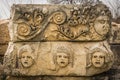 Preserved bas-reliefs with floral ornaments and faces, Demre, Antalya, Turkey. Theater masks Royalty Free Stock Photo