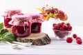 Preserved berry. Glass jar with homemade raspberry jam