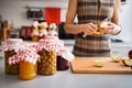 Preserved fruit in glass jars with woman quartering apple Royalty Free Stock Photo