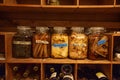 Preserved vegetables in glass jars on a wooden shelf