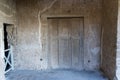 preserved wooden door in pompeii archeological park