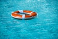 Preserver lifebuoy. Orange lifebuoy in sea on water. Life ring floating of water. Royalty Free Stock Photo