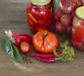 Preserves vegetables in glass on wood background, marinated ferm