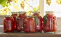 Preserves vegetables in glass on wood background, marinated fermented and pickled fermer food