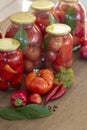 Preserves vegetables in glass on wood background, marinated fermented and pickled fermer food