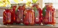 Preserves vegetables in glass on wood background, marinated fermented and pickled fermer food