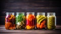 Preserving harvest. 5 jars of pickled vegetables cucumbers, tomatoes, herbs, spices, zucchini, peppers, garlic and other Royalty Free Stock Photo