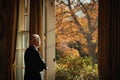 President Joe Biden gazes out the window of the White House in a moment of reflection, Imagine a president in a moment of