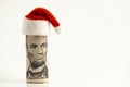 President Lincoln is like Santa Claus. A five-dollar US bill is rolled into a tube and a red cap at the top. New Year or Christmas Royalty Free Stock Photo
