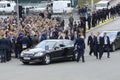 President of Ukraine Petro Poroshenko greeting people, cars and bodyguards nearby. Military parade