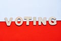 Voting in Poland. Elecion in Poland. Presidential election. Wooden letters on the Polish flag. Word Voting on the background of th