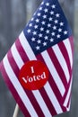 2016 Presidential Election I Voted sticker on small American flag. Royalty Free Stock Photo