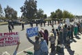 Presidential Motorcade with President George W. Bush past anti-Bush political rally with signs that read Impeach Bush in Tucson