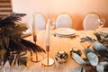 Presidium table setting with empty wine glasses and candles