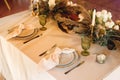 Presidium table setting with green wine glasses and candles