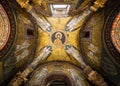 Perspective of religious mosaic showing Jesus surrounded by angels decorating ceiling of catholic church Royalty Free Stock Photo