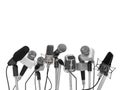 Press conference with standing microphones. Royalty Free Stock Photo