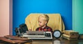 Press photographer work with vintage camera and typewriter. Little photographer typewrite at office desk Royalty Free Stock Photo