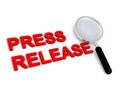 Press release with magnifying glass on white Royalty Free Stock Photo