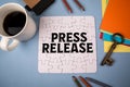 Press Release. White puzzle and office supplies on table Royalty Free Stock Photo