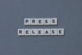 ' Press Release ' word made of square letter word on grey background