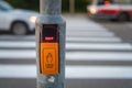 Pressed button for traffic light with wait signal at pedestrian crossing