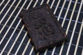 Pressed tea brick with Chinese hieroglyphs. Royalty Free Stock Photo