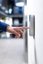 Pressing button on security keypad, person entering office building
