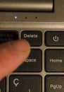 pressing delete key on laptop. finger pressing delete key Royalty Free Stock Photo