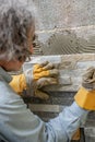 Pressing ornamental tile in a glue on a wall