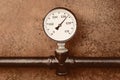 Pressure gauge on a background of vintage pipe closeup engineering design Royalty Free Stock Photo